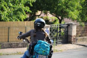 woman riding with motorbike tail bag