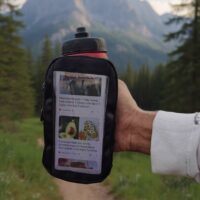 Handheld bottle and phone pouch